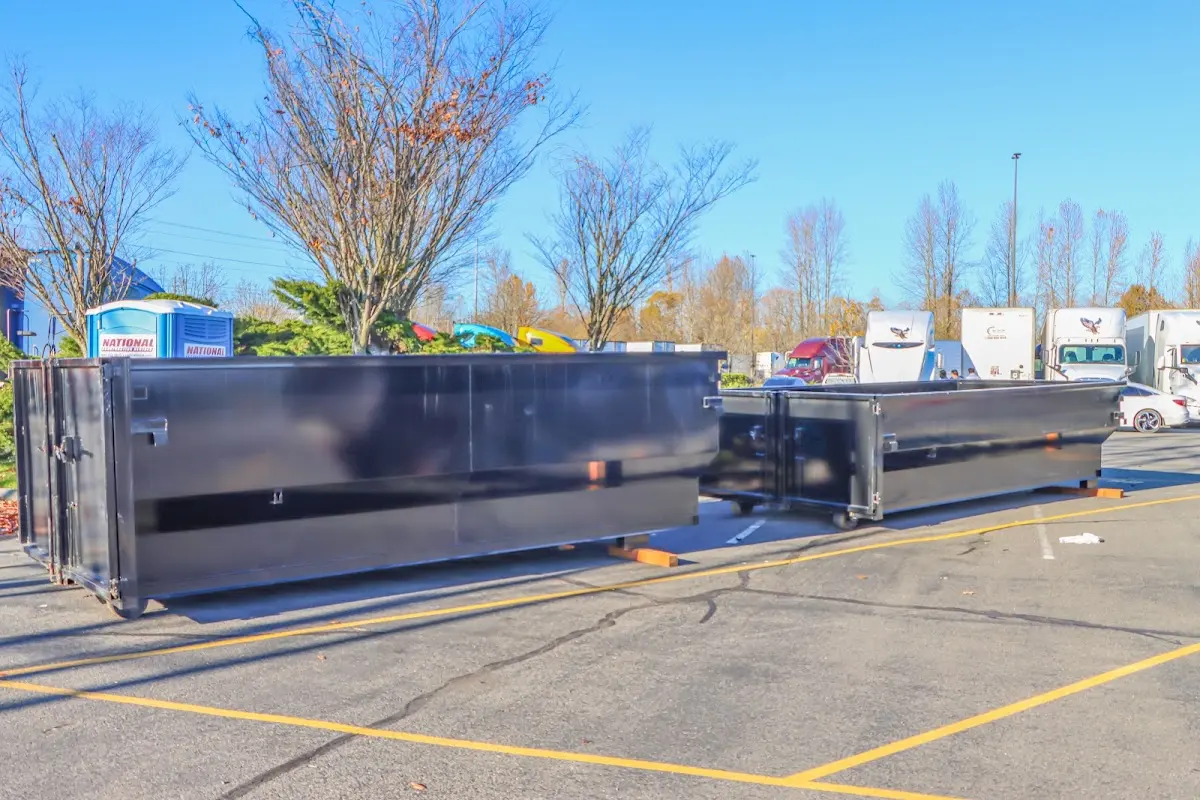 Professional dumpster rental service with roll-off container on residential driveway in Cedar Rapids